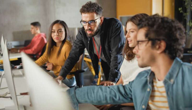 a group of people sitting at a desk