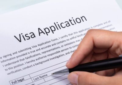 A person filling up a Visa Application form